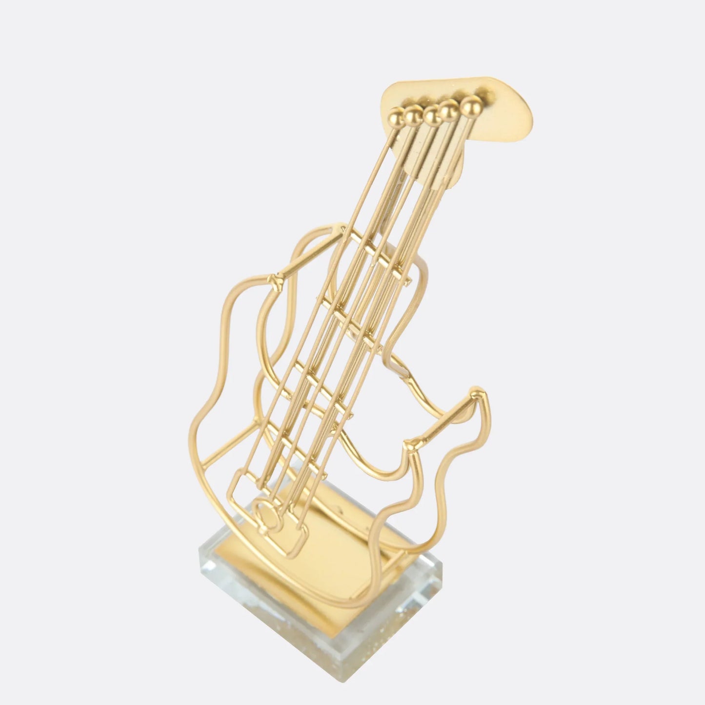 Metallic hollow guitar sculpture on display shelf