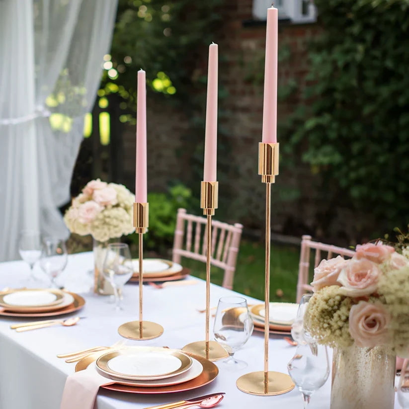 3 gold candle stands styled on a table