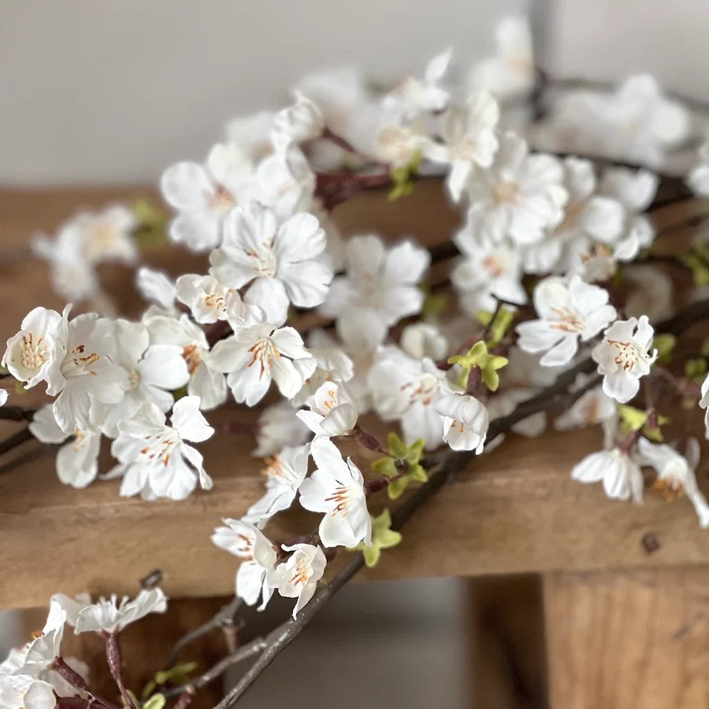 Faux cherry blossom branch styled in a vase