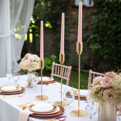 3 gold candle stands styled on a table