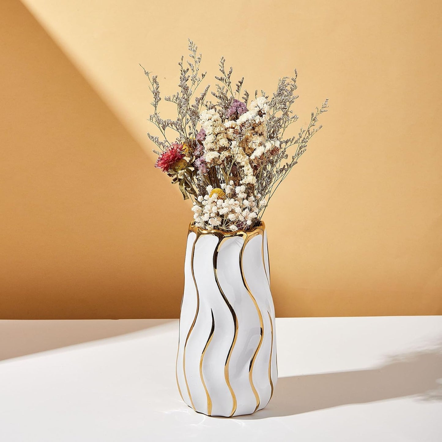 Striped ceramic vase styled on a table
