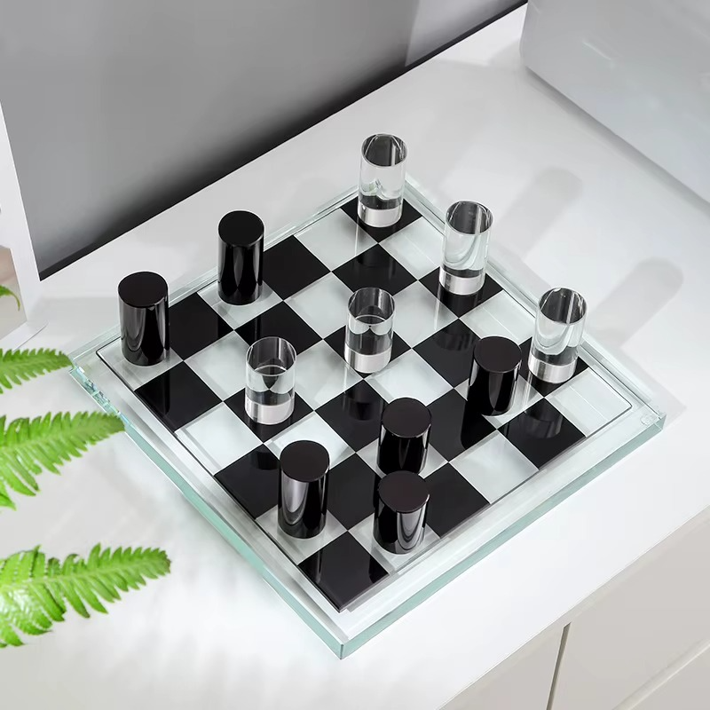 Crystal-style glass chess set with clear and black glass pieces on a checkered glass board