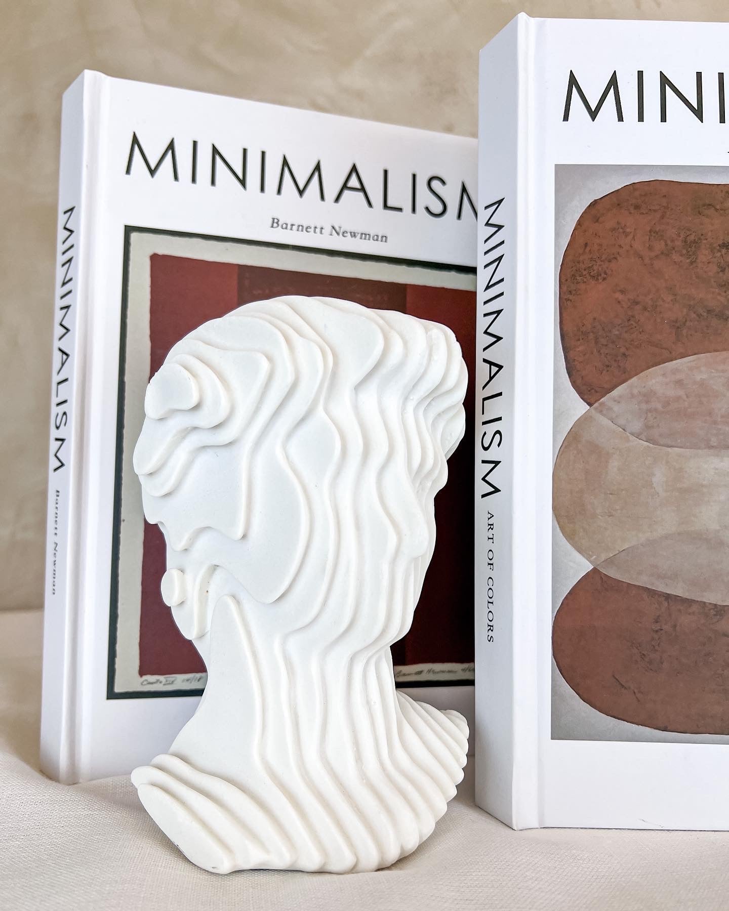 Michelangelo fluted bust sculpture on bookshelf