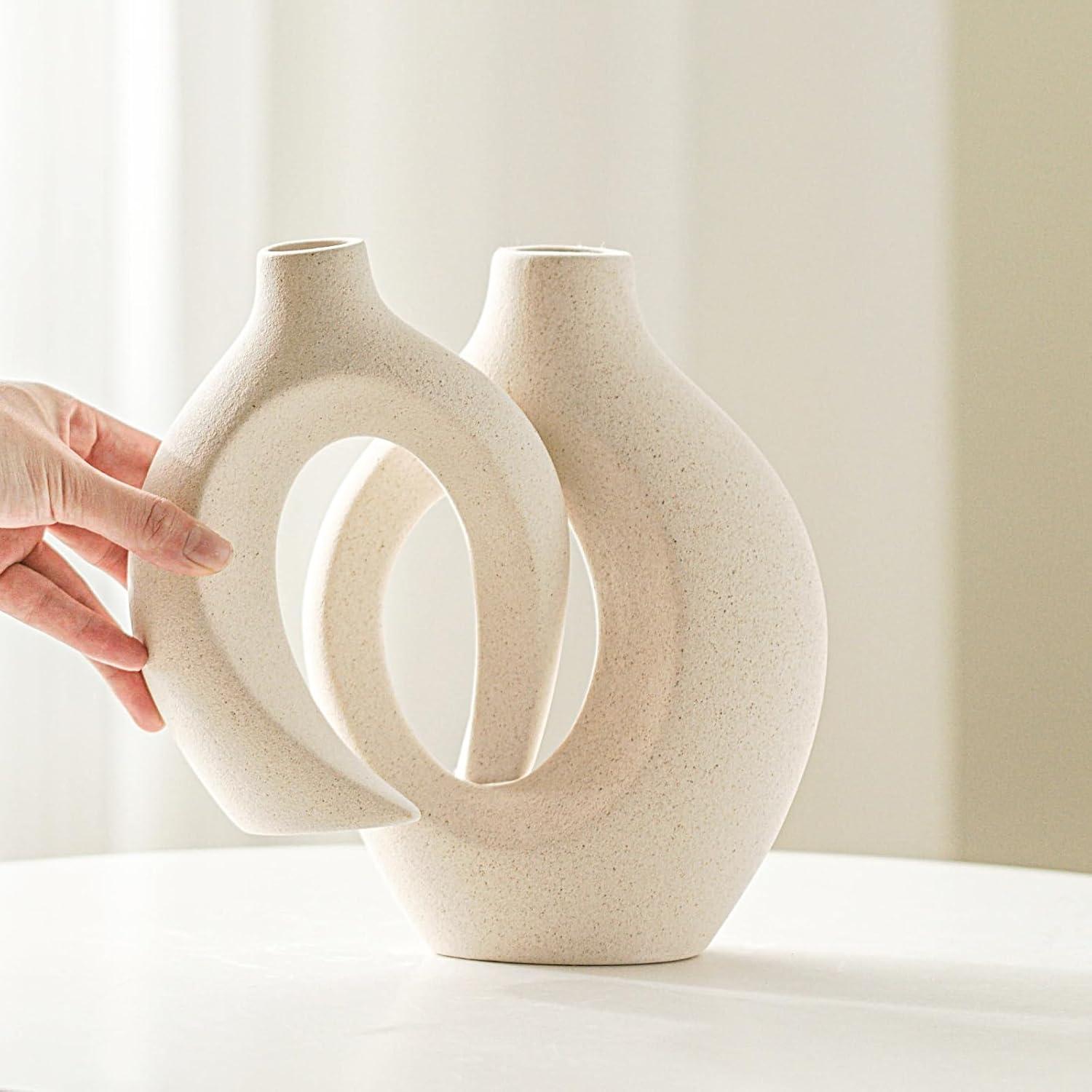 Hollow ceramic vases pair styled on coffee table