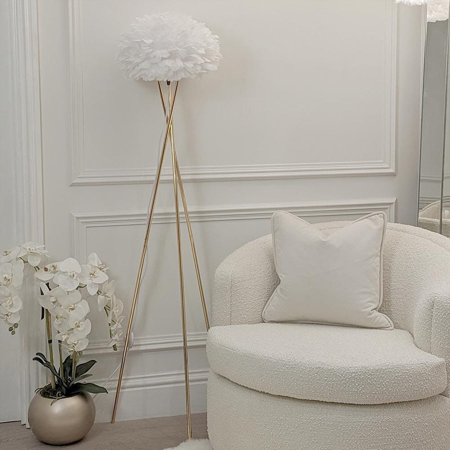 Tripod feather floor lamp styled in a living room