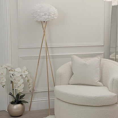 Tripod feather floor lamp styled in a living room