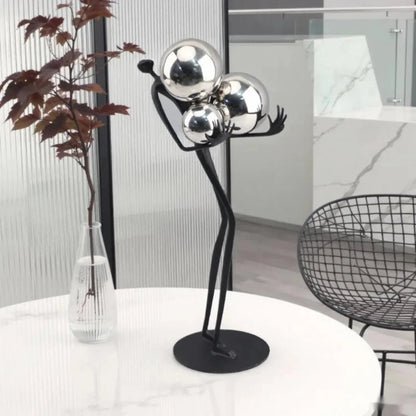 Decorative tabletop statue figure holding metal balls