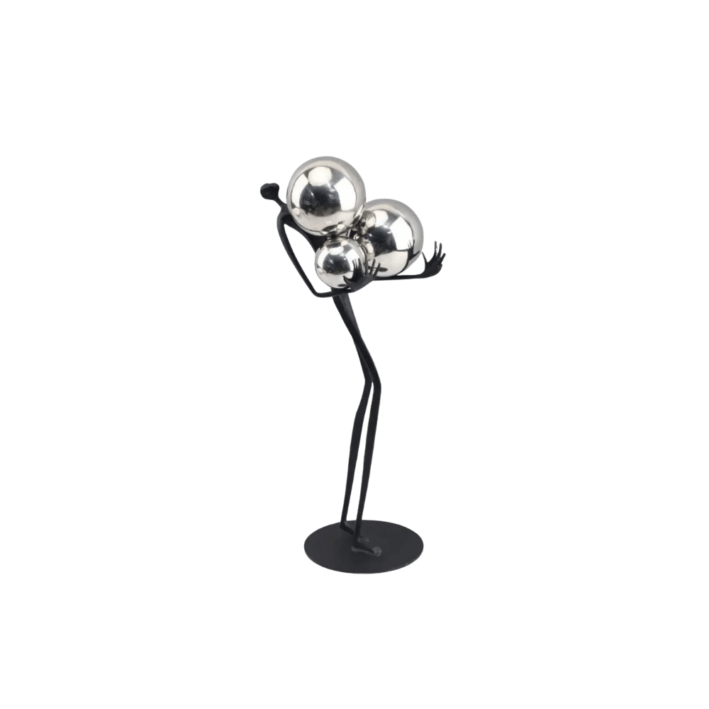 Decorative tabletop statue figure holding metal balls