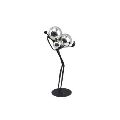 Decorative tabletop statue figure holding metal balls