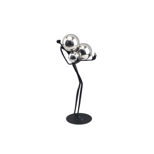 Decorative tabletop statue figure holding metal balls