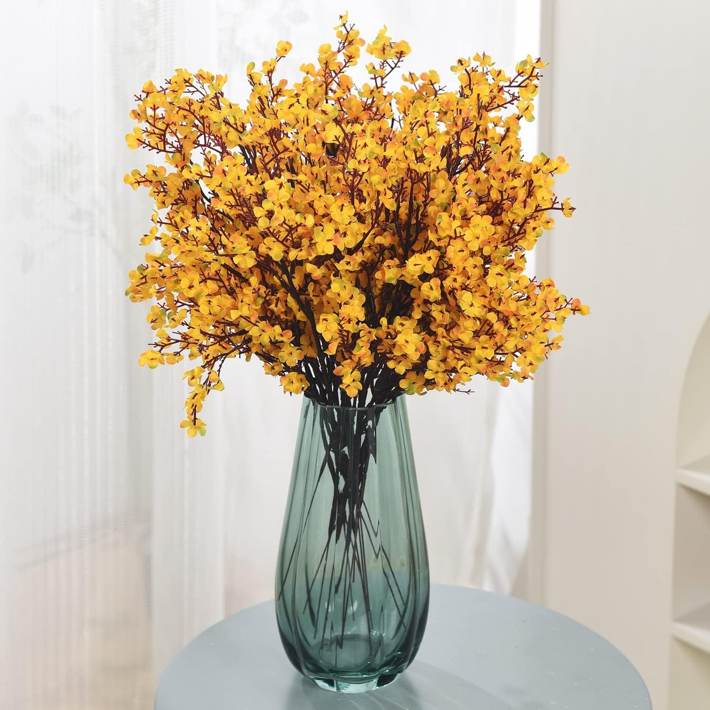 Yellow baby breath stem styled in a vase
